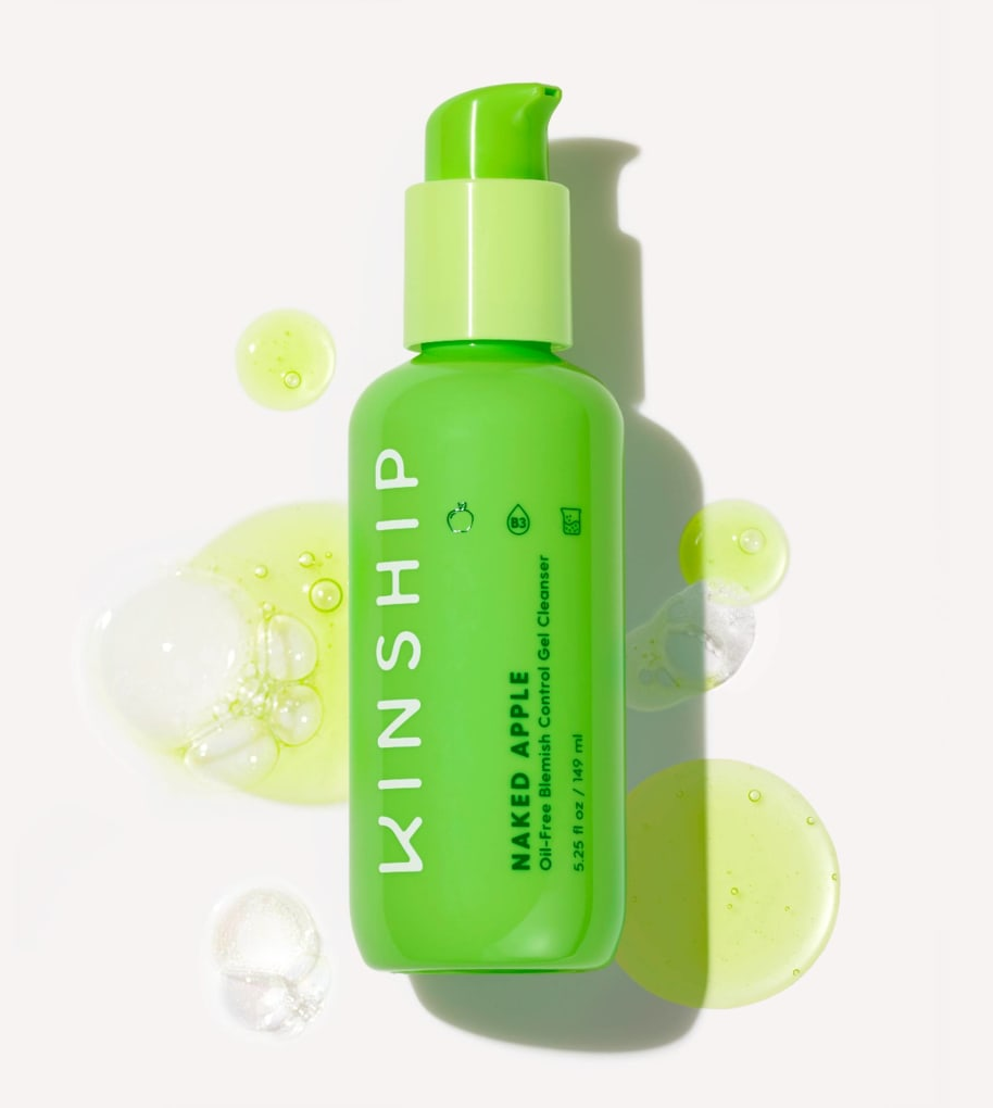 the bottle and drops of cleanser which is a translucent green