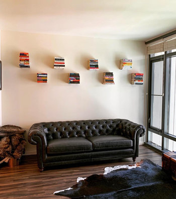 a reviewer using the invisible bookshelves to create a floating display