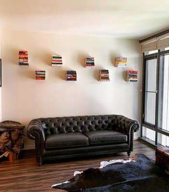 a reviewer using the invisible bookshelves to create a floating display