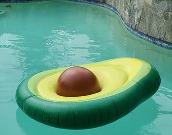 reviewer's avocado float in the pool with brown ball as the pit