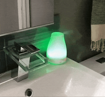 A gif of a reviewer's essential oil diffuser changing color