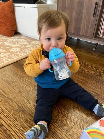 buzzfeed editor's son drinking out of a blue sippy cup
