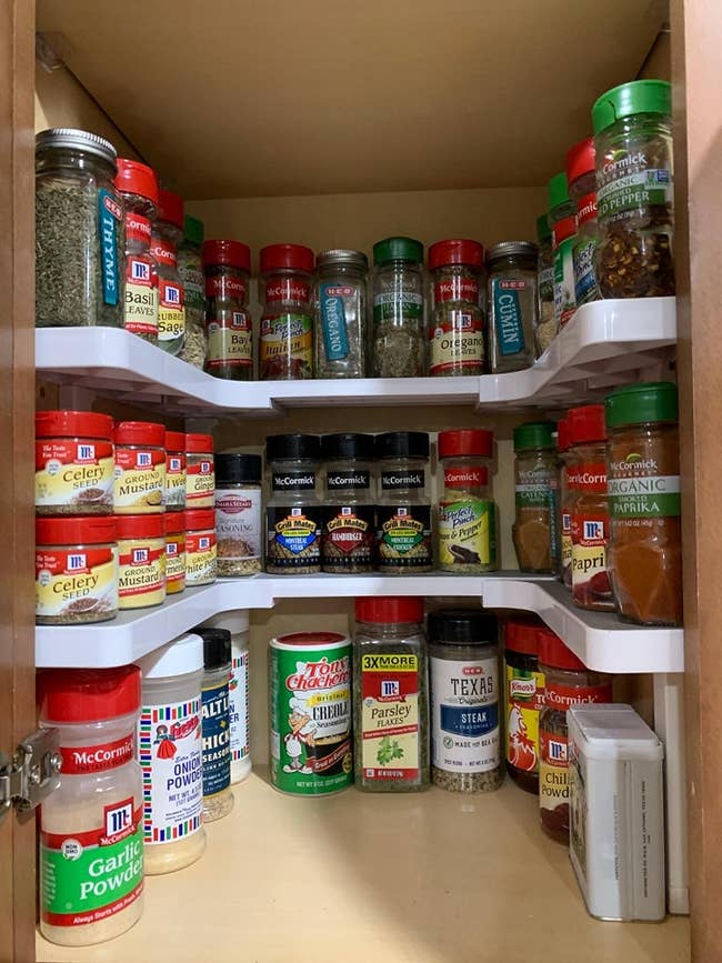 the u-shaped shelf with spices organized on it