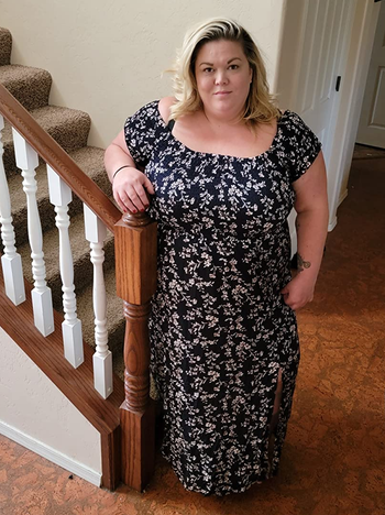 reviewer wearing the dress in navy floral