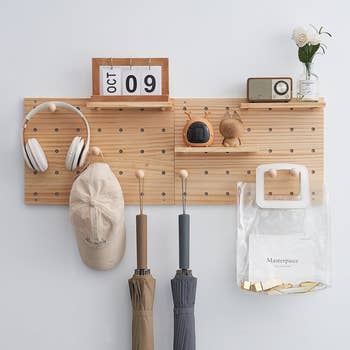 the light wood pegboard with shelves and peg hooks