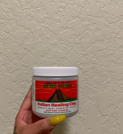 Reviewer holding their jar of Aztec Secret healing mask
