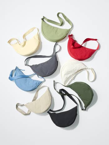 Assortment of 9  crescent-shaped bags successful  assorted  colors, arranged successful  a circular signifier   connected  a level  surface