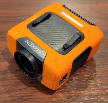 Portable orangish tyre inflator with integer show and nozzle, suitable for car exigency kits and roadside assistance