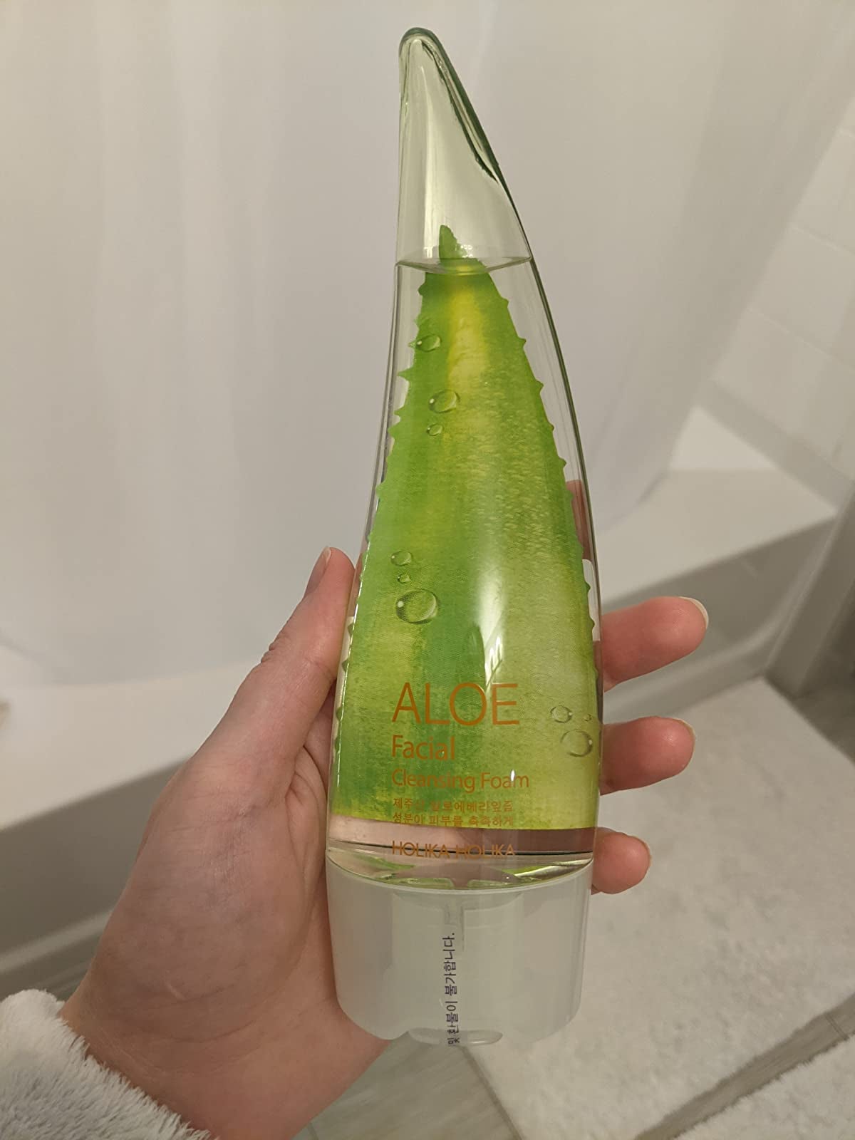 Reviewer holding aloe facial cleansing foam