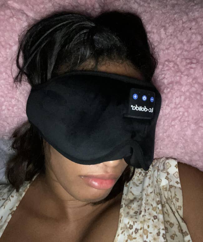 Person wearing a achromatic slumber disguise connected a fluffy pillow