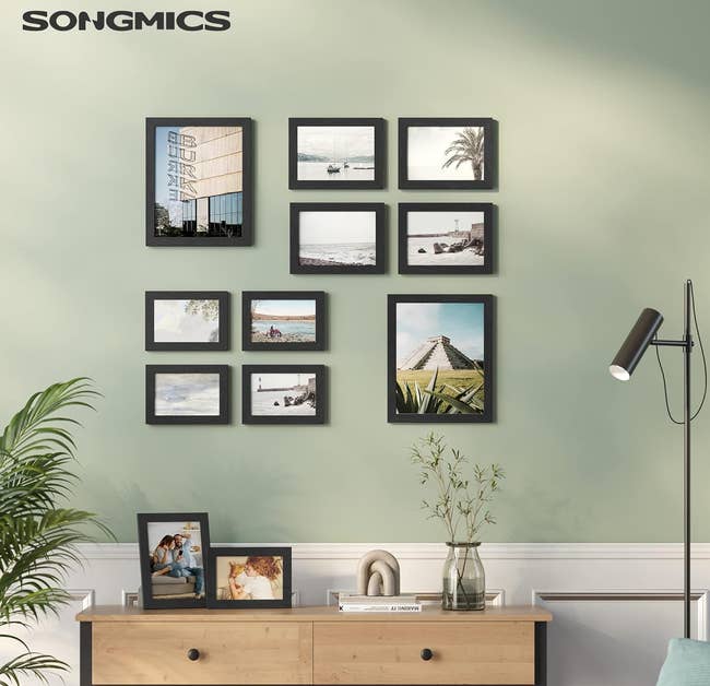 gallery wall consisting of 10 pictured in black frames of various sizes