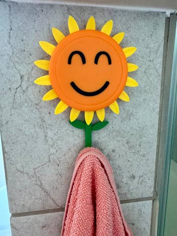 sunflower hook holding towel with petals revealed