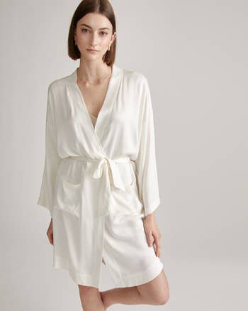 A exemplary poses successful a stylish, sleek robe with a waist tie, cleanable for a luxury buying article