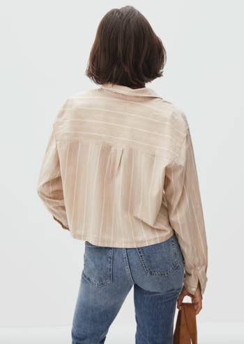 model showing the back view of the light brown striped shirt