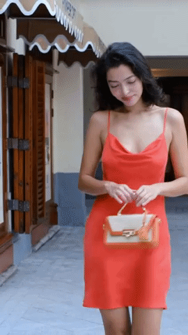 Video of model wearing product and walking showing front view of spaghetti straps and a square back