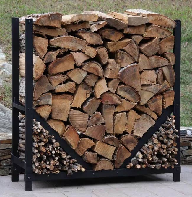 the black rack filled with logs and two compartments in each bottom corner filled with kindling 