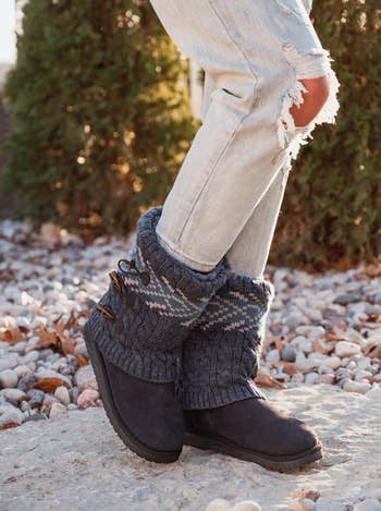 model wearing the gray boots with a cozy sweater lining