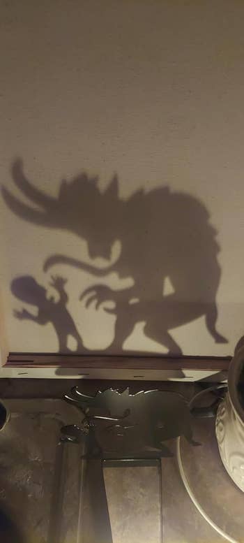 A shadiness   creation  country   shows a monster and a tiny  figure