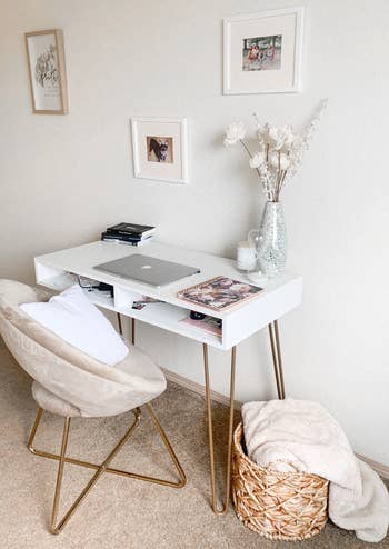 a reviewer uses the white velvet chair at their desk