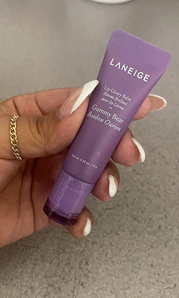 image of reviewer's hand holding gummy bear scented lip balm