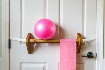 barre attached to door with equipment hanging 