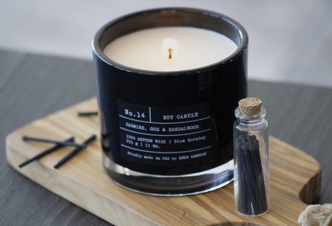 the candle in a black glass jar with white wax