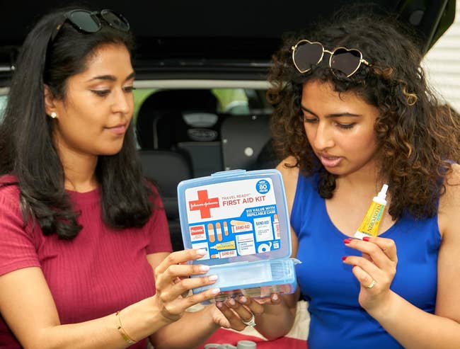 two models holding question archetypal assistance kit