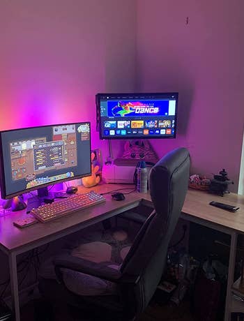 LED lights adding pink and orange backlighting to a desk setup
