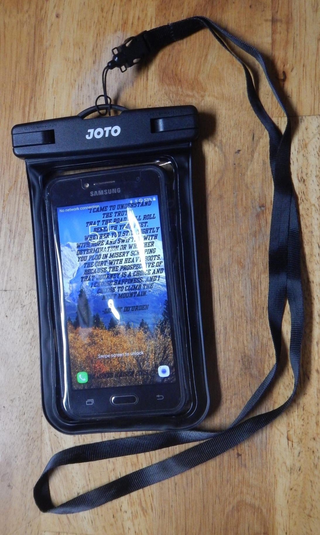 reviewer image of a smart phone inside a black waterproof phone pouch