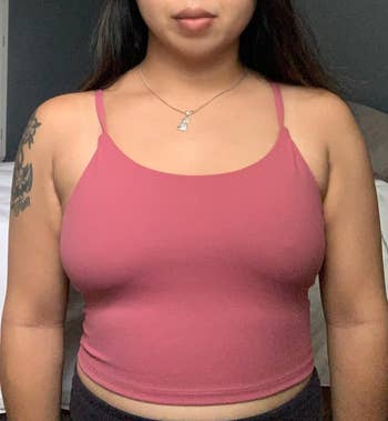 Woman wearing a fitted spaghetti strap harvest  apical  and a delicate necklace, showcasing casual style