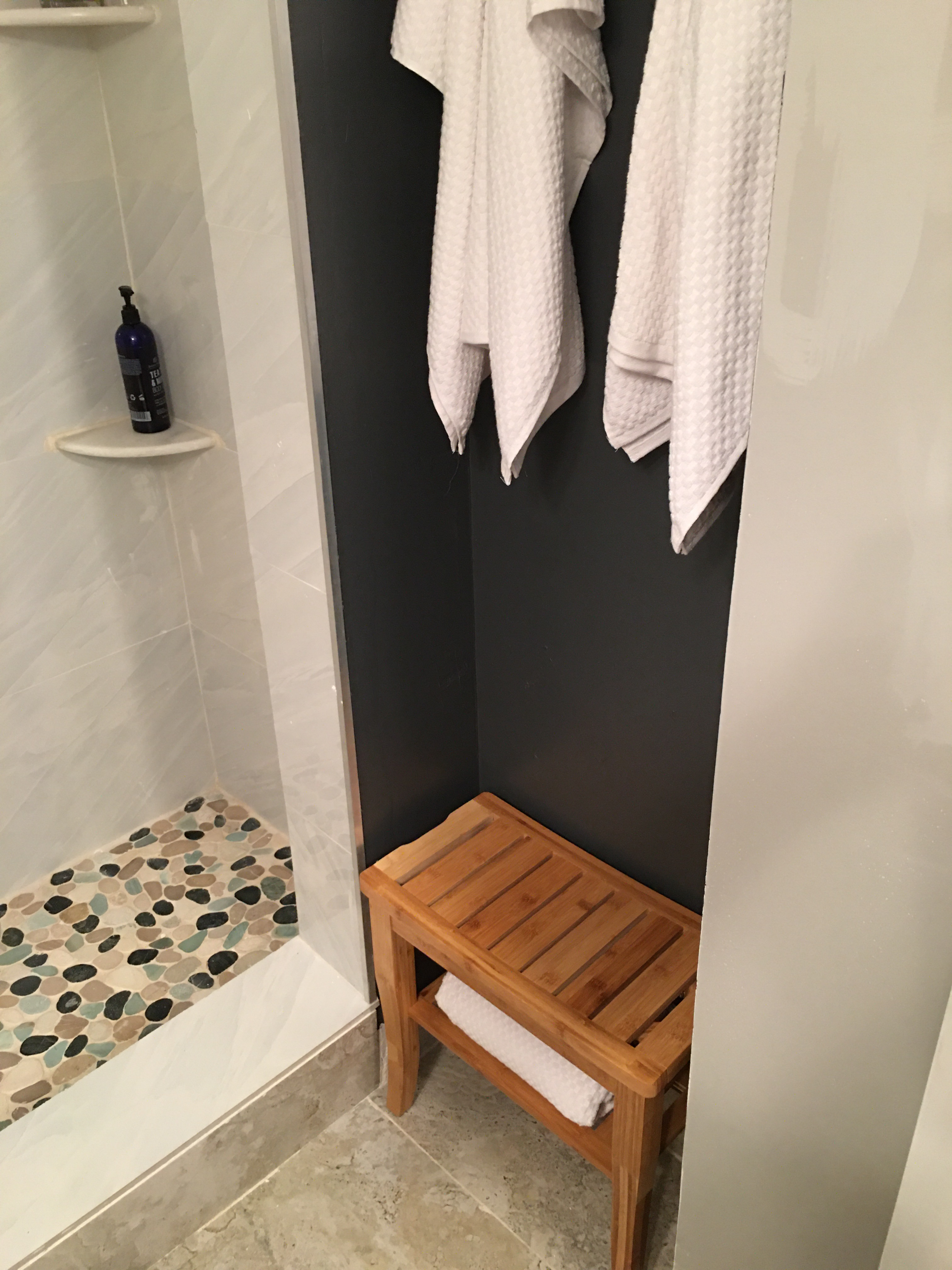 two of the white waffle weave towels hanging in a bathroom