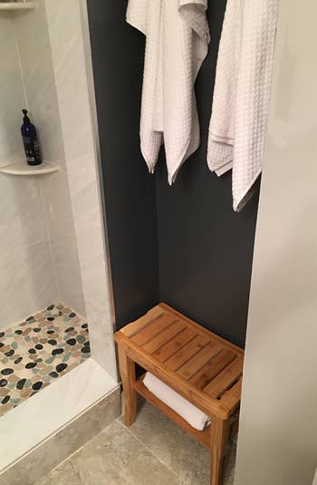 two of the white waffle weave towels hanging in a bathroom