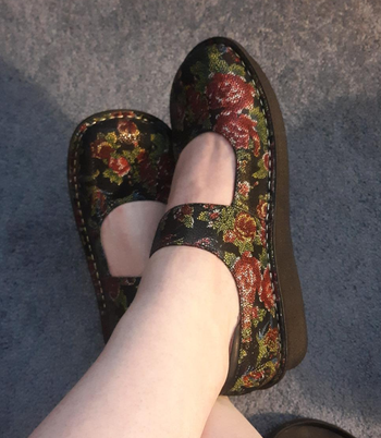 Reviewer wearing floral shoes
