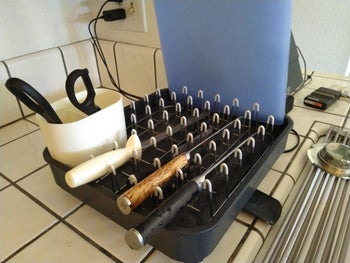 reviewer photo of black plastic dish rack full of dishes