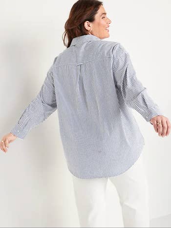 the same model showing the button down shirt from the back