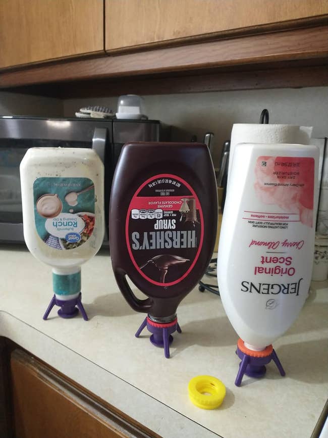 reviewers bottles of ranch, chocolate syrup, and lotion with valves on them
