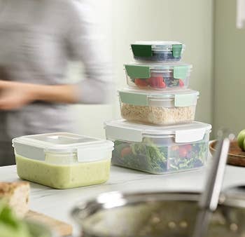 the green ombre food containers filled with food and stacked on top of one another
