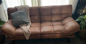 reviewer's brown faux leather futon