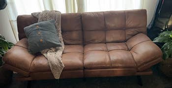 reviewer's brown faux leather futon