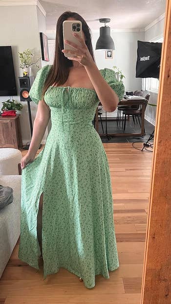 reviewer wearing the green dress with puff sleeves