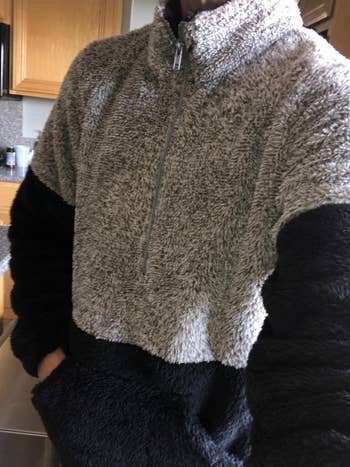 person wearing grey and black fuzzy quarter-zip