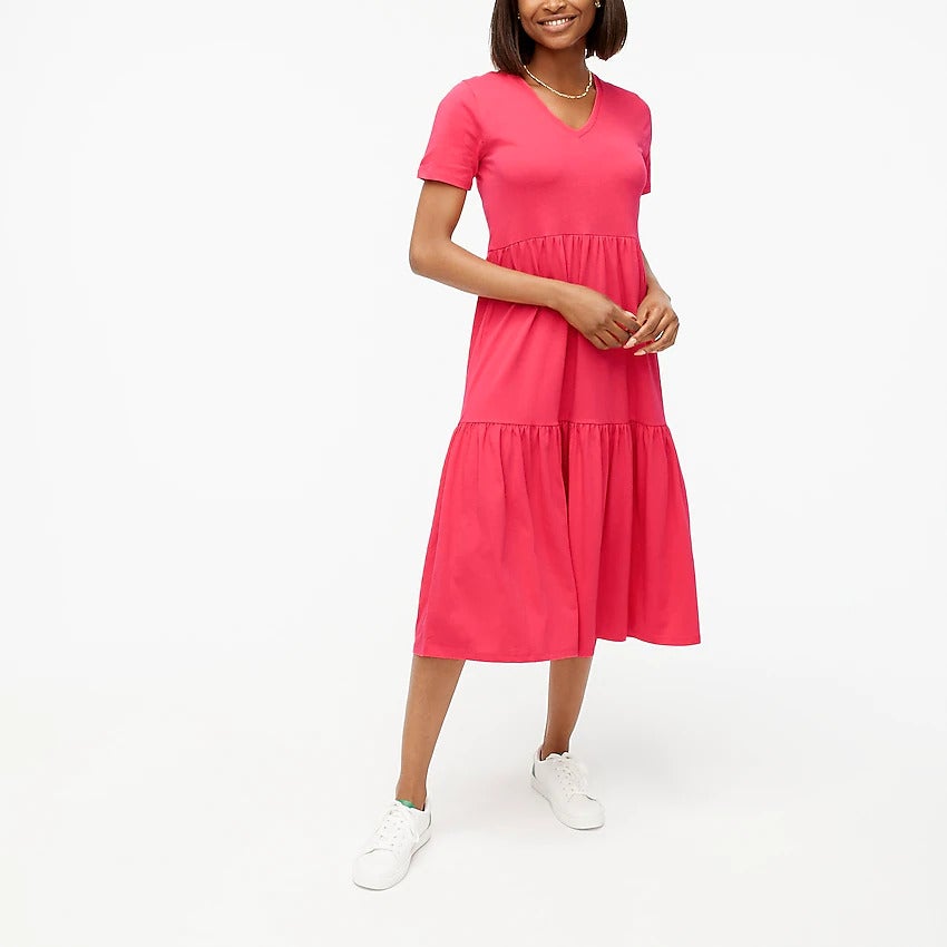 model wearing the bright coral dress with white sneakers