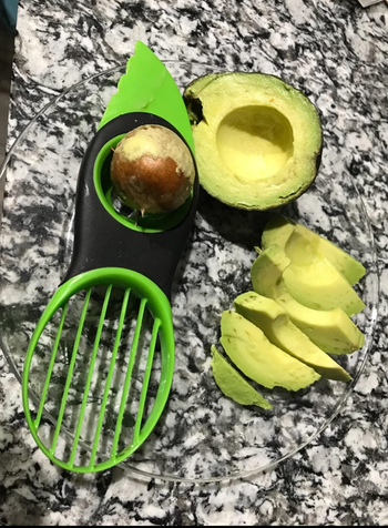 Reviewer image of the tool next to a pitted and sliced avocado 