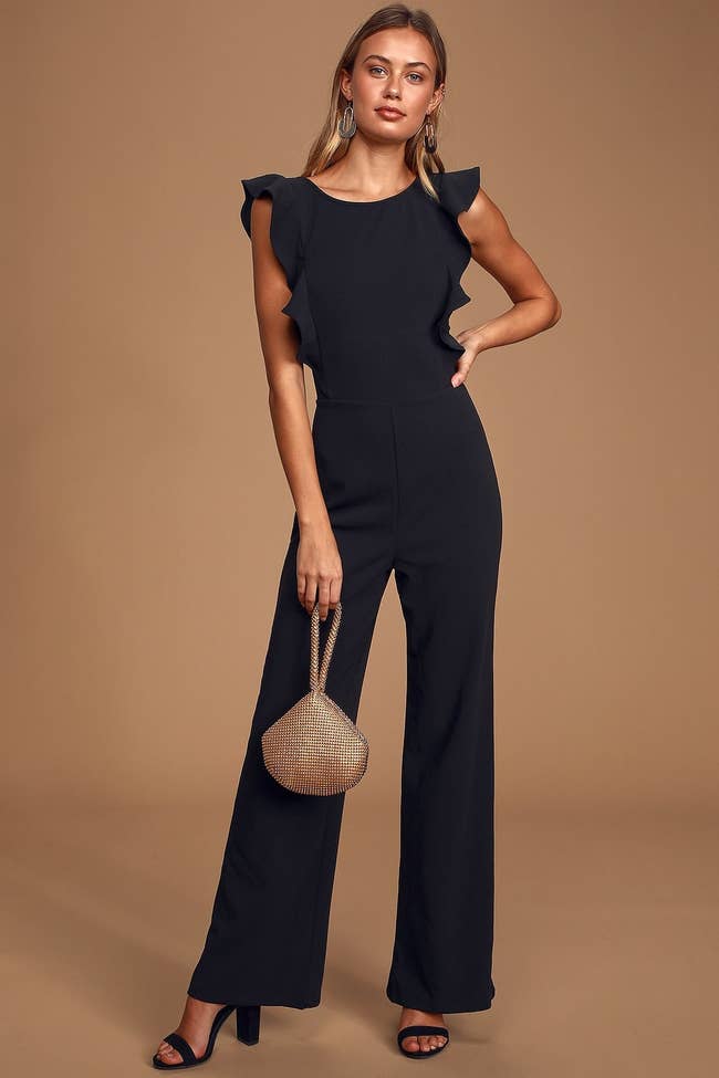 model in black sleeveless jumpsuits with ruffle details at the arms