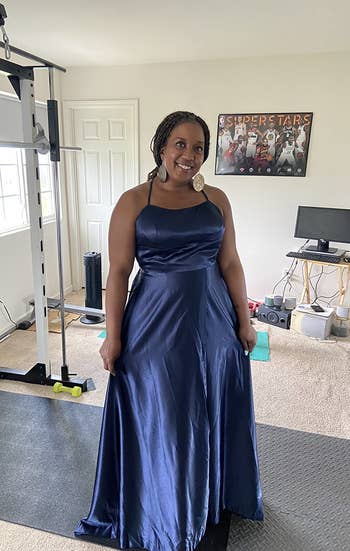 a reviewer poses in the navy blue gown