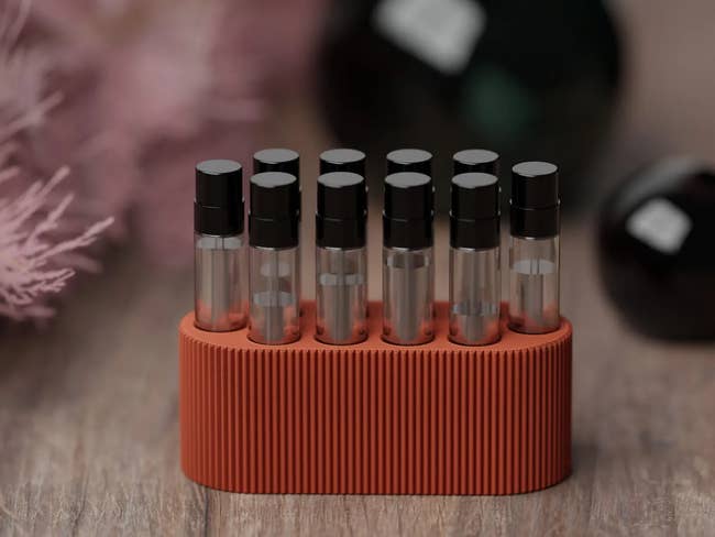 Set of perfume illustration   vials successful  a ribbed holder connected  a woody  surface, suitable for showcasing successful  a buying  context