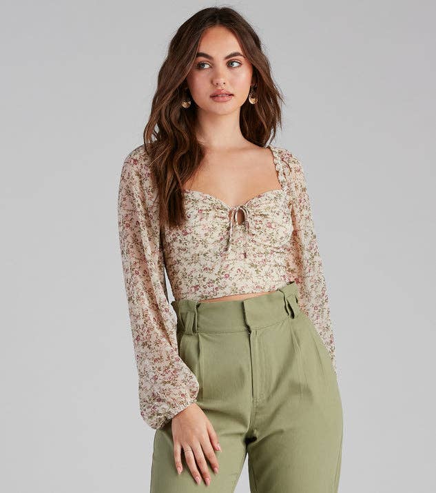 Model is wearing pale green pants and a light tan sweetheart line chiffon top with lantern sleeves
