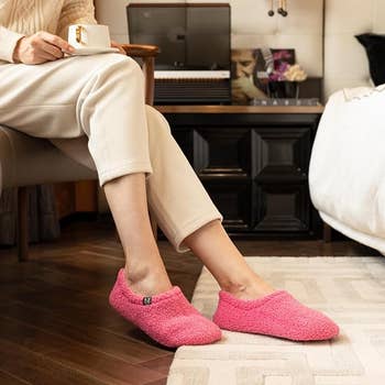 Reviewer in pink version of the slippers 