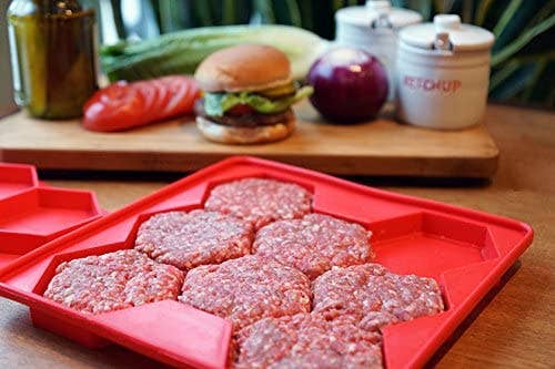 A red silicone mold for hexagon shaped burger patties