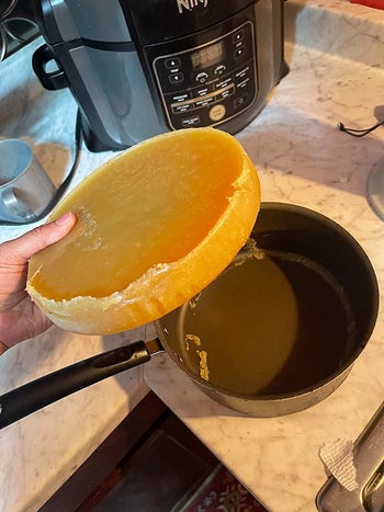 reviewer holding solidified oil above their pan